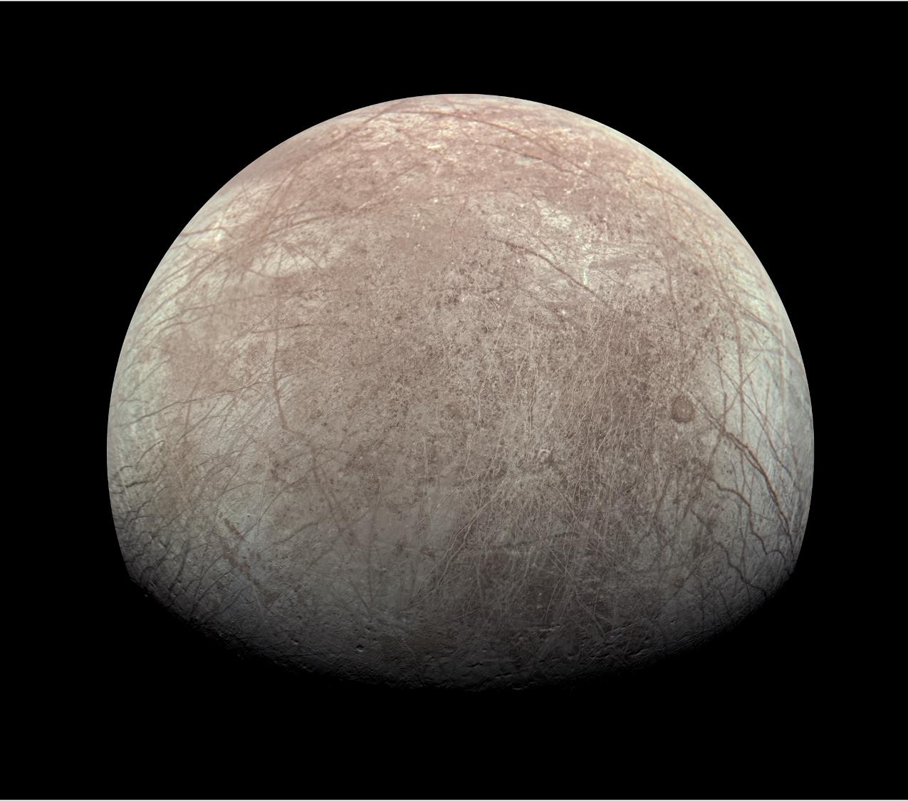 Europa has reddish brown lines and patches in this image from Juno.