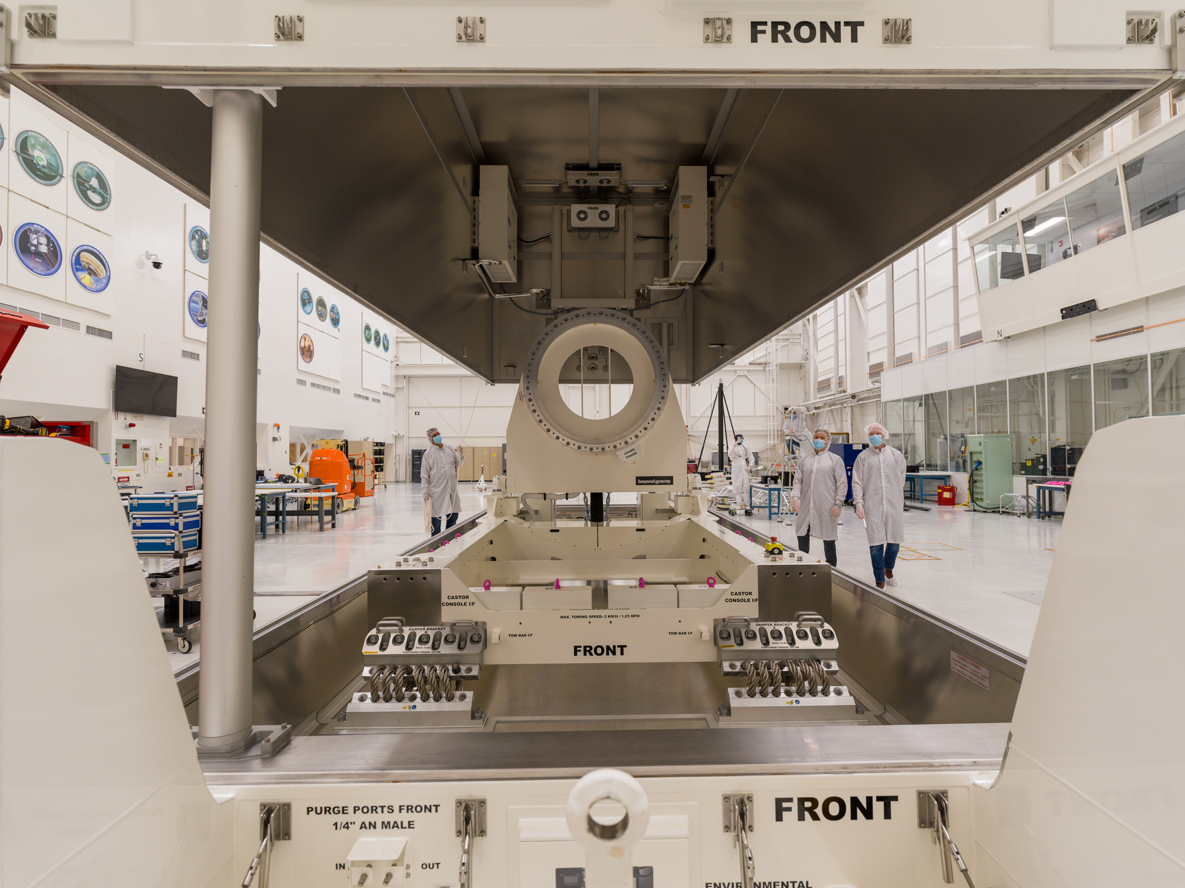 A close-up view of a large cream-colored ring that's part of equipment that will be used to build NEO Surveyor.