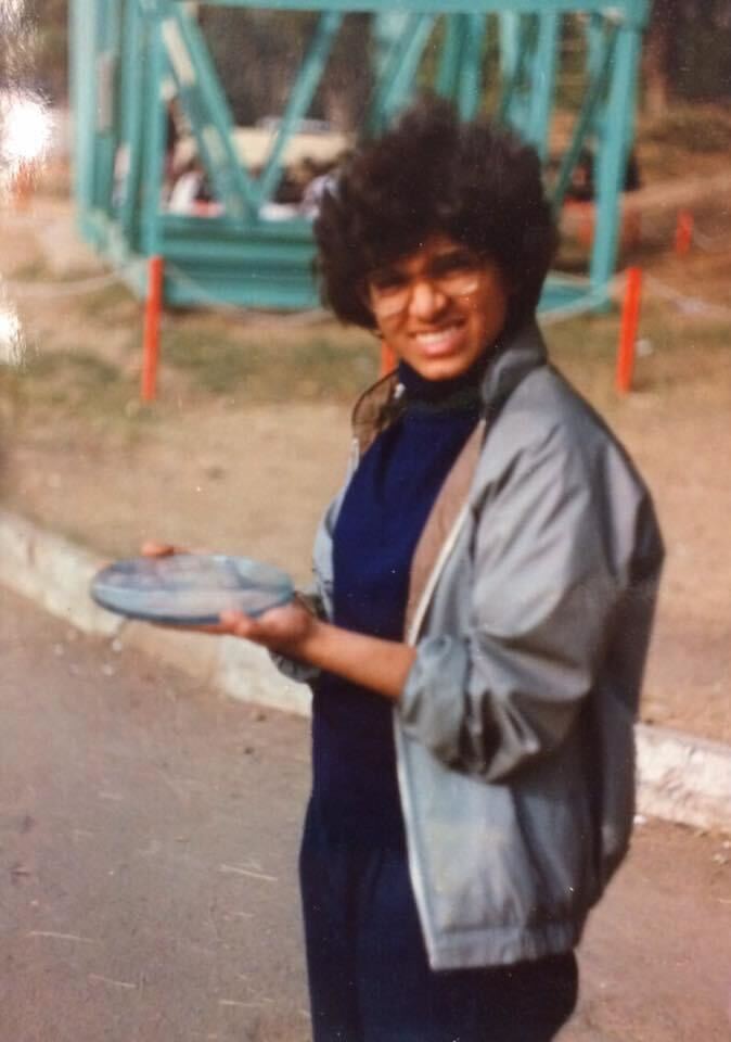 A woman holding a telescope mirror