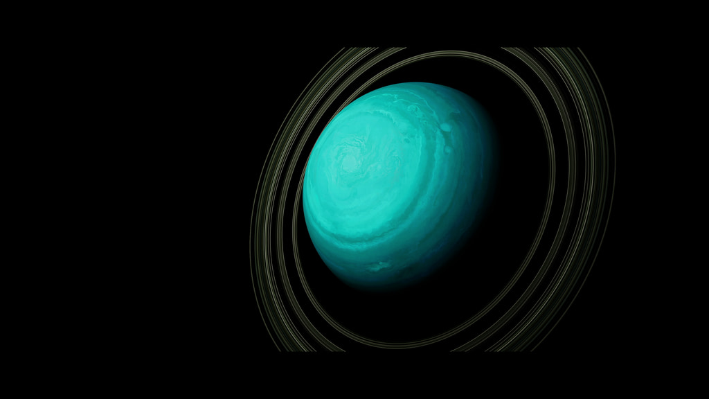 A blue-green orb is shown surrounded by multiple thin yellow-brown rings.