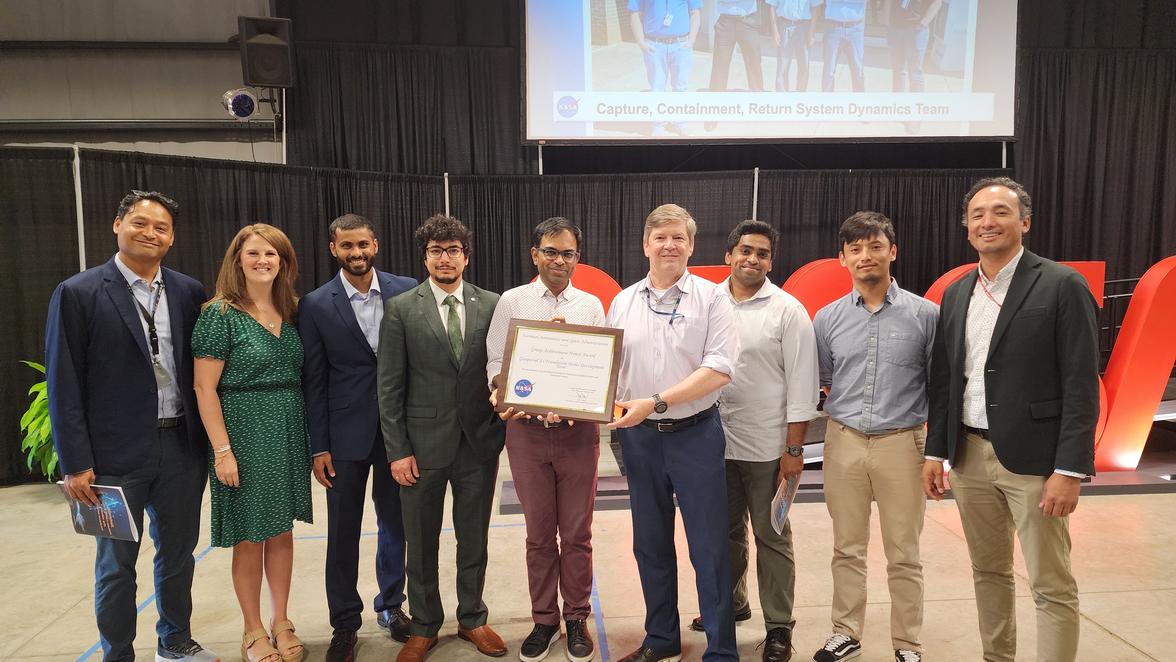 Members of the NASA Impact and IBM Research teams accept their certificate after winning the NASA Marshall Group Achievement Award.