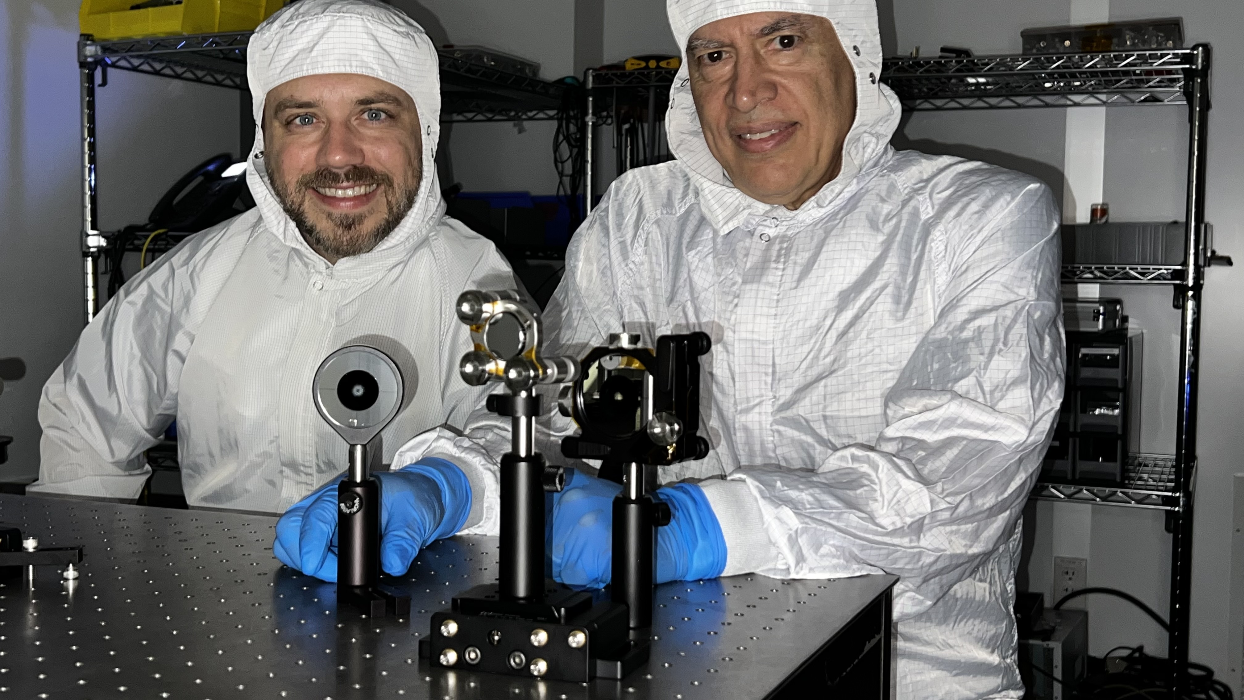 Image of Tyler Groff and John Hagopian with coronagraph components and inset closeup of apodizer.