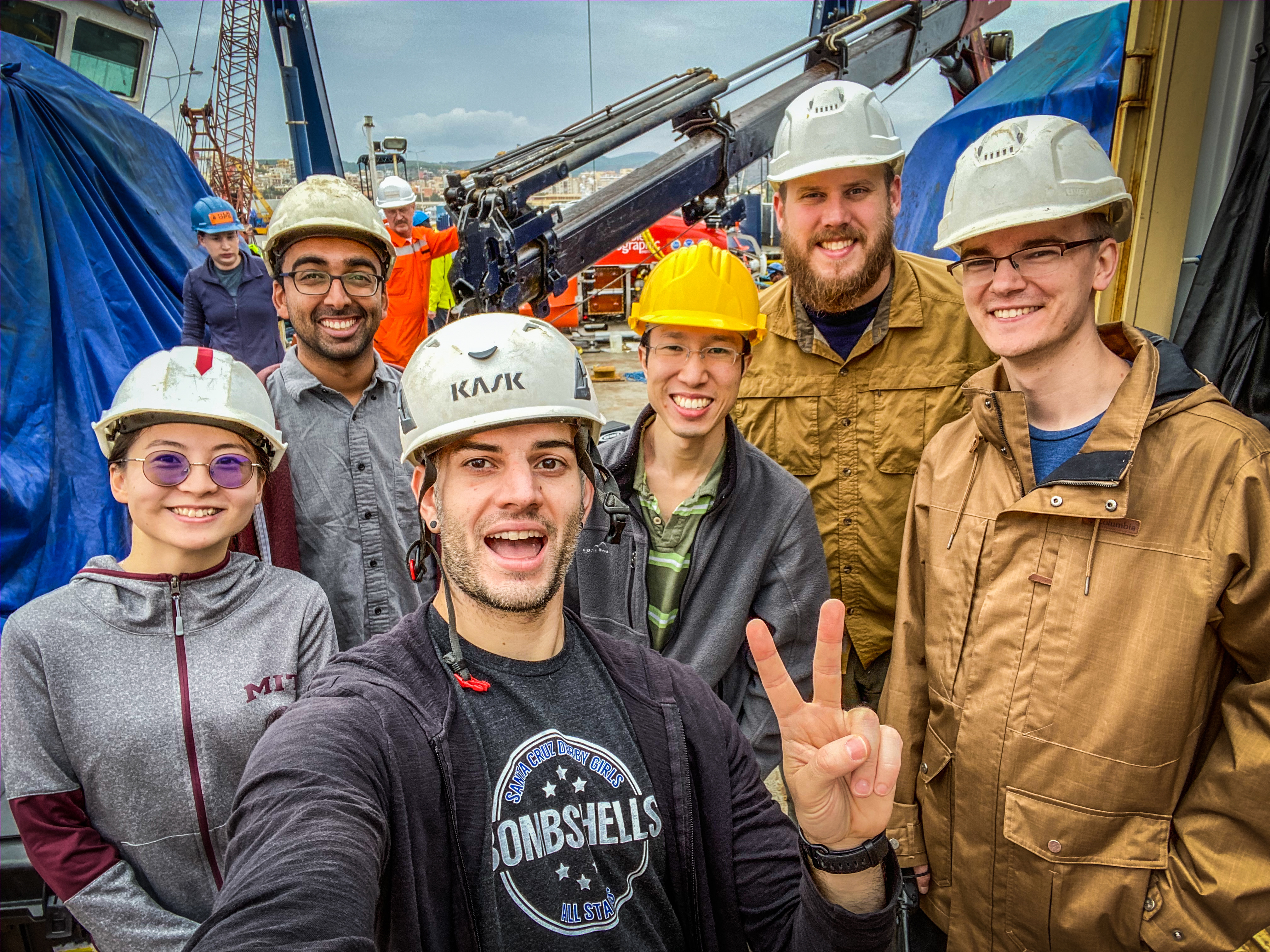 The filmmaker of Our Alien Earth, Mike Toillion, holds up a peace sign while taking a selfie with members of the mission planning team.