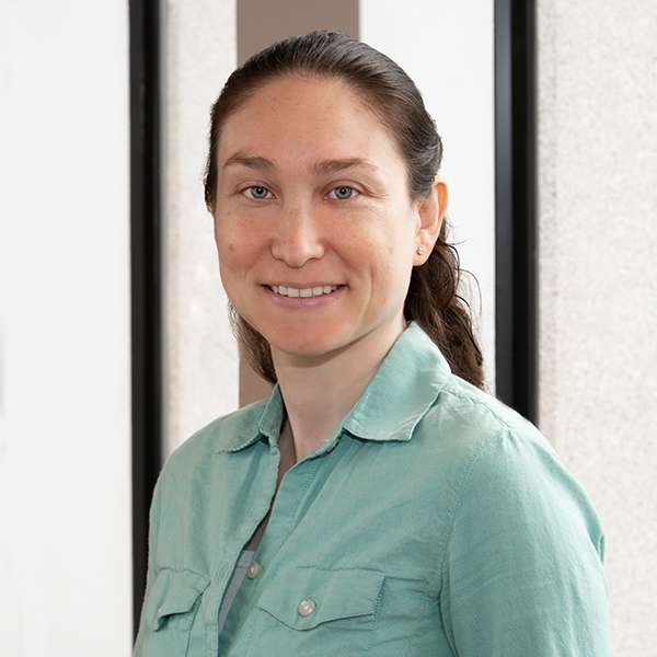 A woman with long hair is smiling. She is scientist Johanna Nagy.