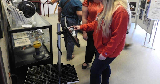 A Patterson Observatory visitor interacts with a NASA's Eyes Kiosk