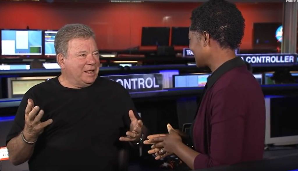 Actor William Shatner speaks with NASA/JPL engineer Tracy Drain.