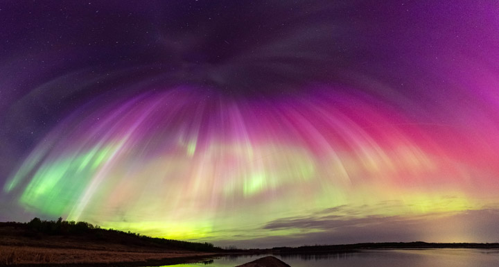 The colors of an aurora come from atoms and molecules being energized by colliding with energetic particles in the upper atmosphere. The most common color is green, which is produced when oxygen is excited by electrons around 60 mi (100 km) above Earth's surface.<br><em><sub>Image credit: Gunjan Sinha, used with permission</sub></em><br> 