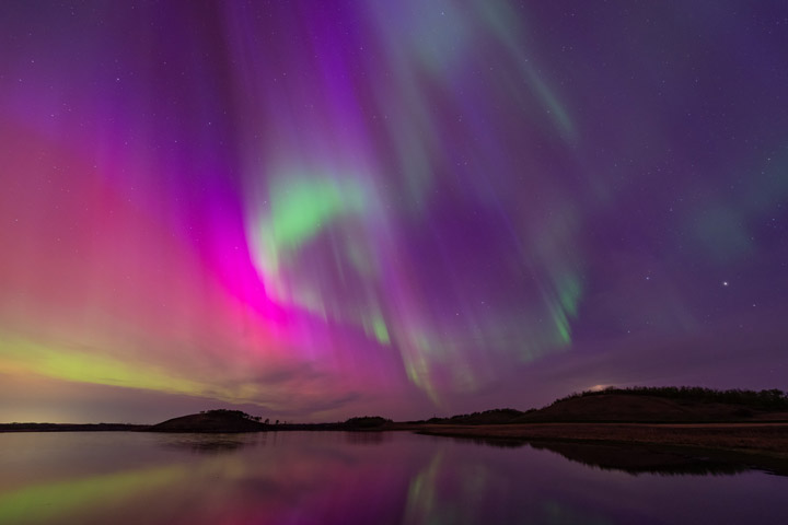 Ribbons of colorful aurora dance across the sky.