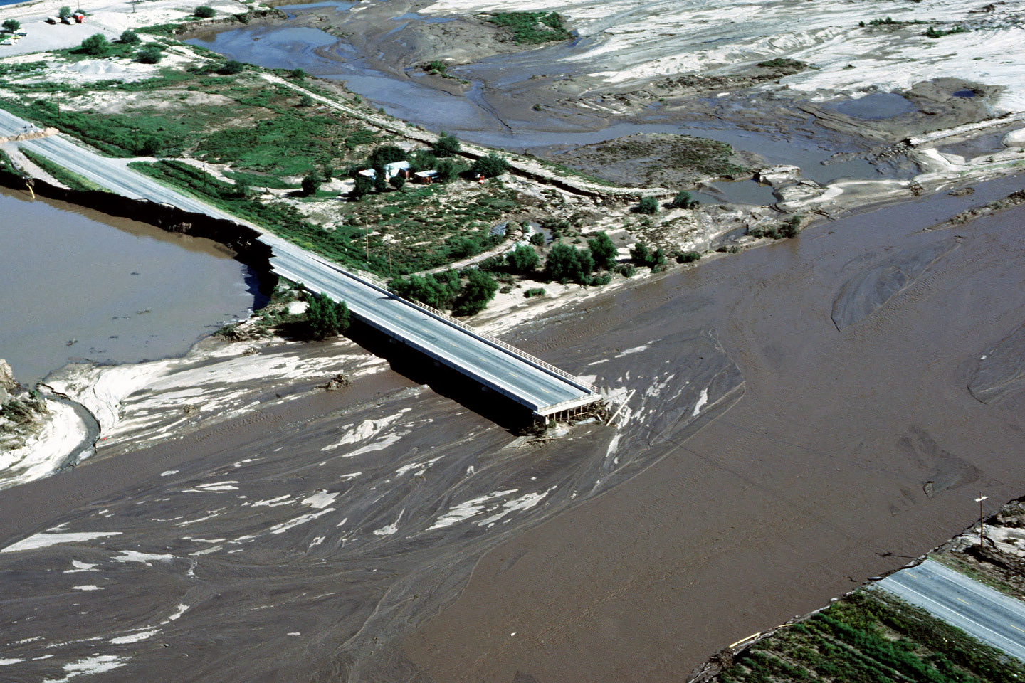 Floodwater from a river swollen with rains during the 1983 El Niño damaged bridges and property in in the Tucson, Arizona, area.