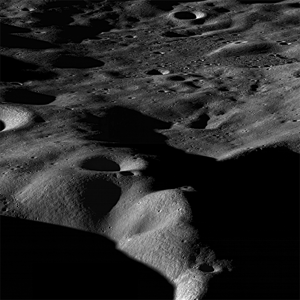 The Moon's surface in shades of gray and black, a rolling, rising and falling landscape marked with craters in deep shadow. The landscape is seen somewhat from the side rather than directly above.