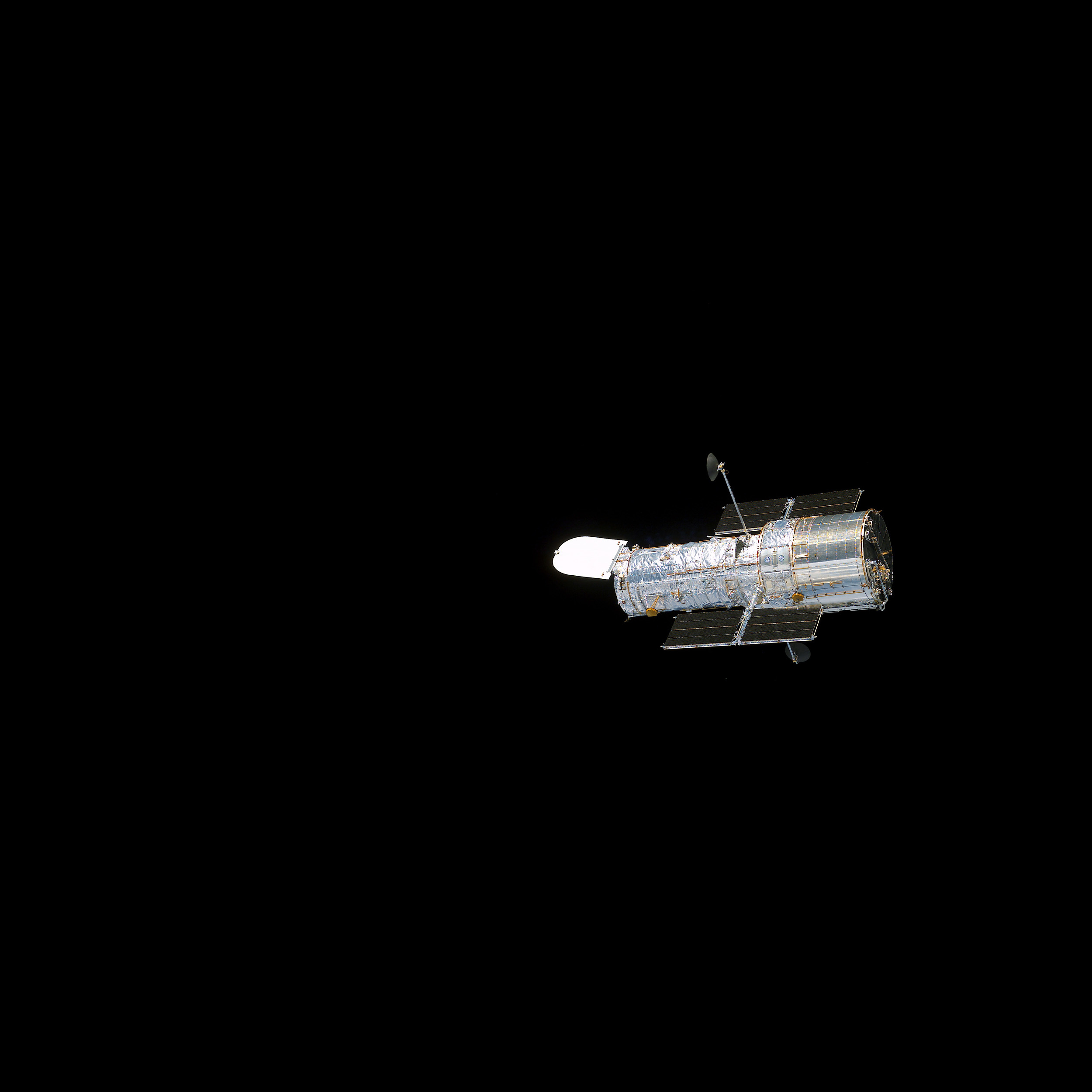 A silver spacecraft floating in space.