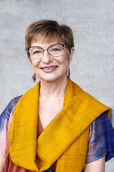 A photograph of a woman wearing an orange dress.