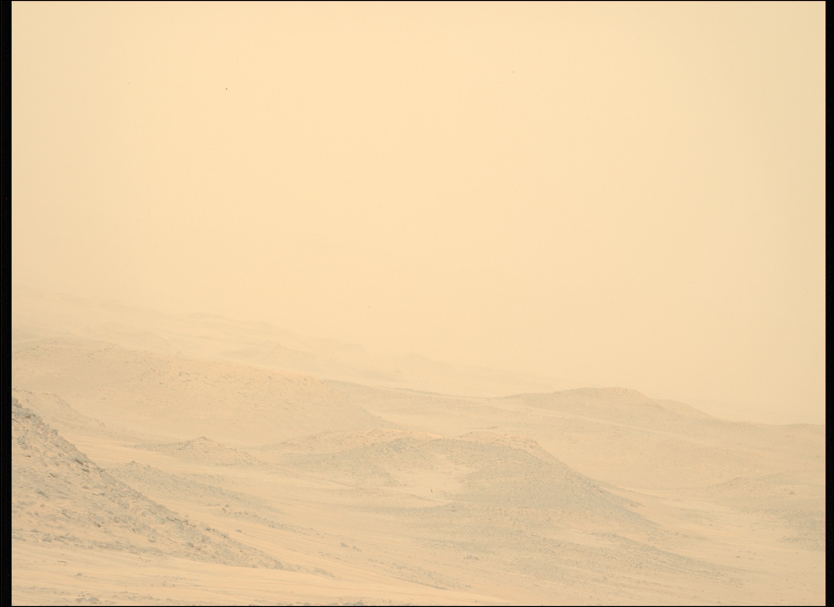 A color image from the Martian surface shows dunes extending from the left side of the frame down toward the bottom right corner, barely visible through a thick haze of pale yellowish-orange that covers the entire scene.