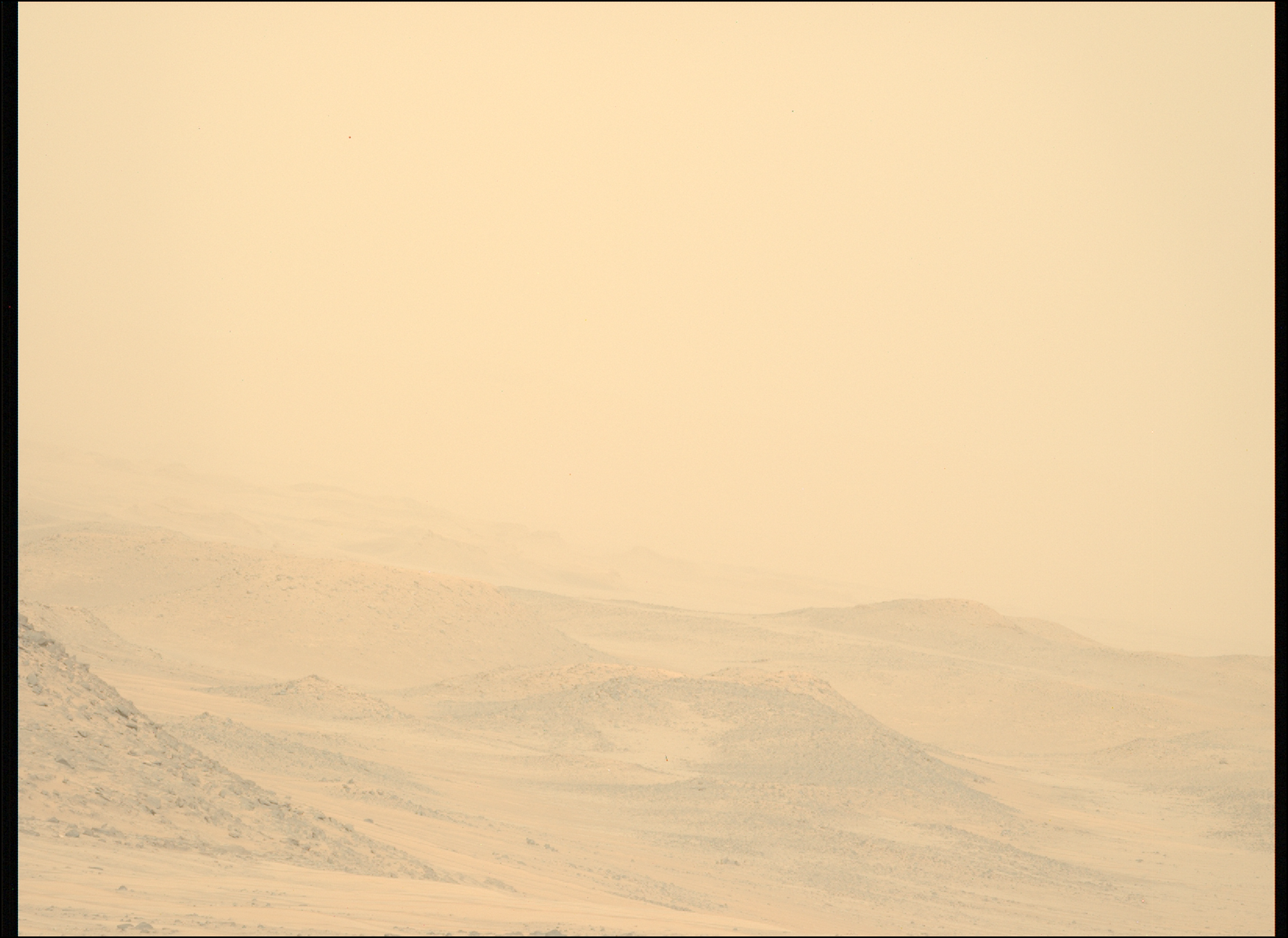 A color image from the Martian surface shows dunes extending from the left side of the frame down toward the bottom right corner, barely visible through a thick haze of pale yellowish-orange that covers the entire scene.