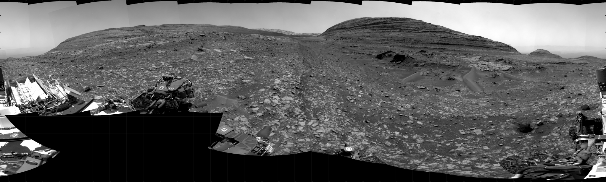 A grayscale panoramic image of the Martian surface