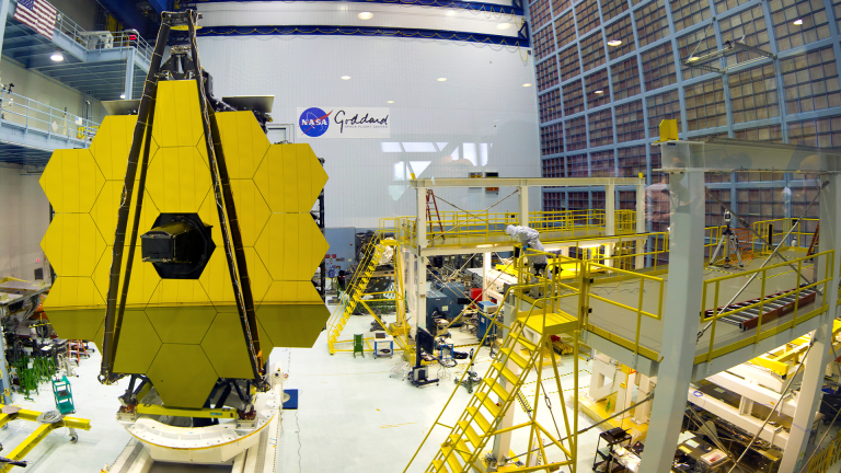 Full view of the Goddard Clean Room with the Webb Primary Mirror on test stand in left side foreground with other clean room structures in the background and right side foreground.