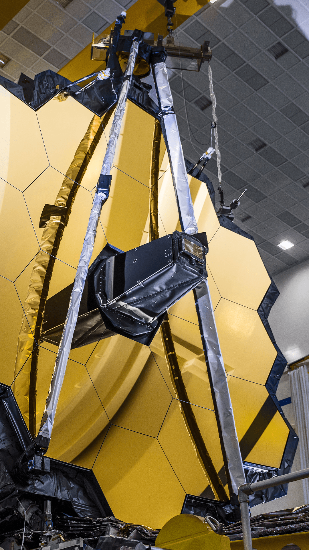 Super closeup vertical view of Webb Primary Mirror in the left side foreground.