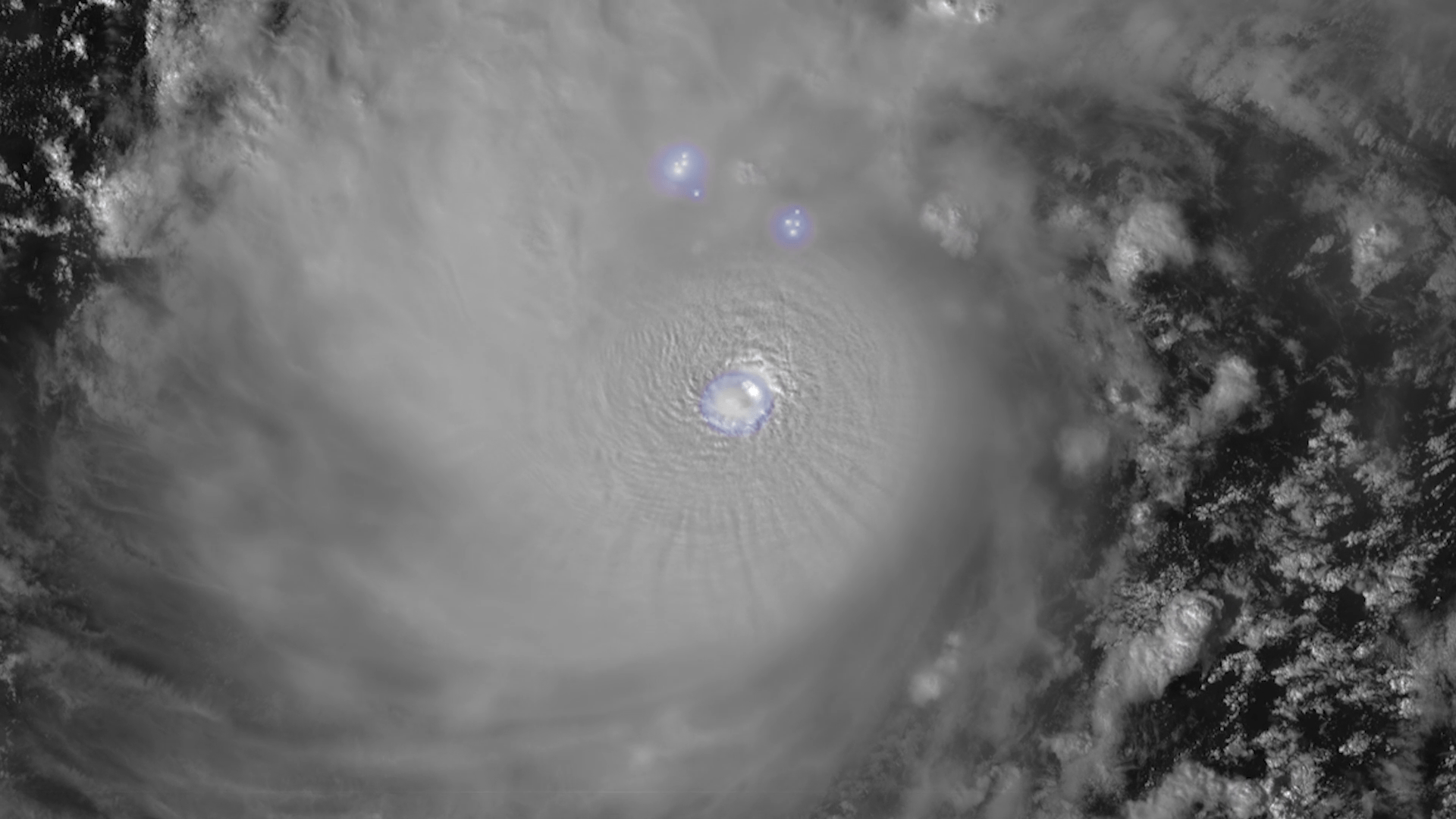 An image of a hurricane with light blue glowing highlights showing where lightning strikes are occuring.