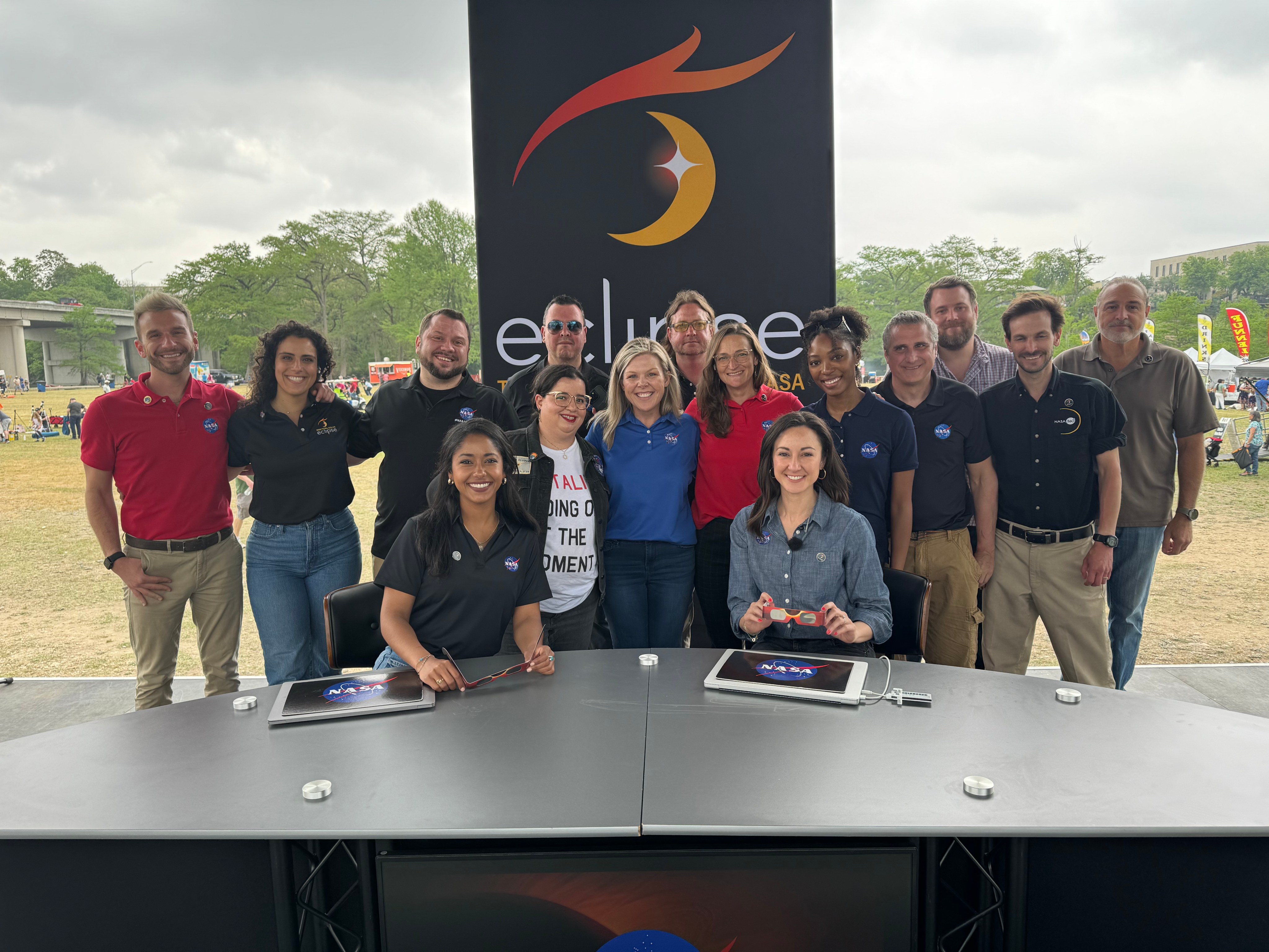 The eclipse broadcast team at the Kerrville, Texas location poses for a picture on stage.