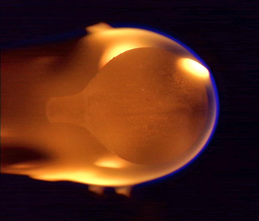 This image shows a 4-cm diameter sphere of acrylic burning in microgravity. The flame appears near the end of the burn, having engulfed the entire sphere after growing from a small ignition point on the right side.