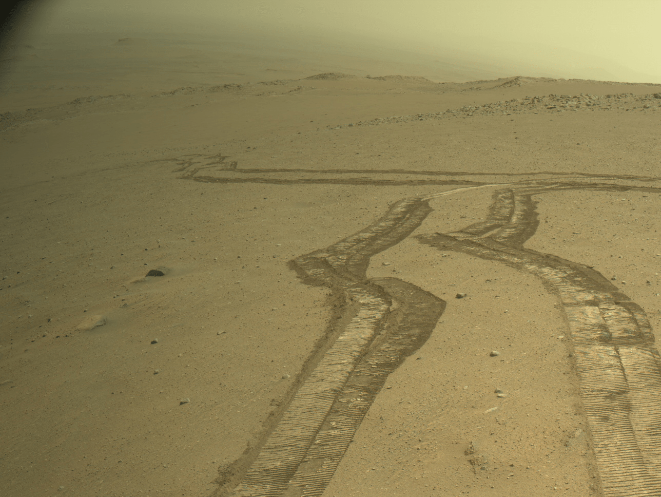 Image from Perseverance’s Right Navigation Camera, looking back towards rover tracks from past drives, into Jezero crater. The camera is located high on the rover mast, and here the rover is looking back in the direction of the Jezero crater floor.