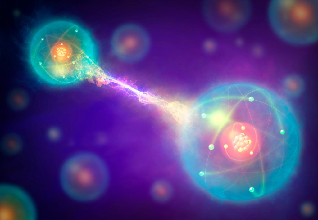 Graphic showing two particles with an electric-like link between them, with many other particles in the background.