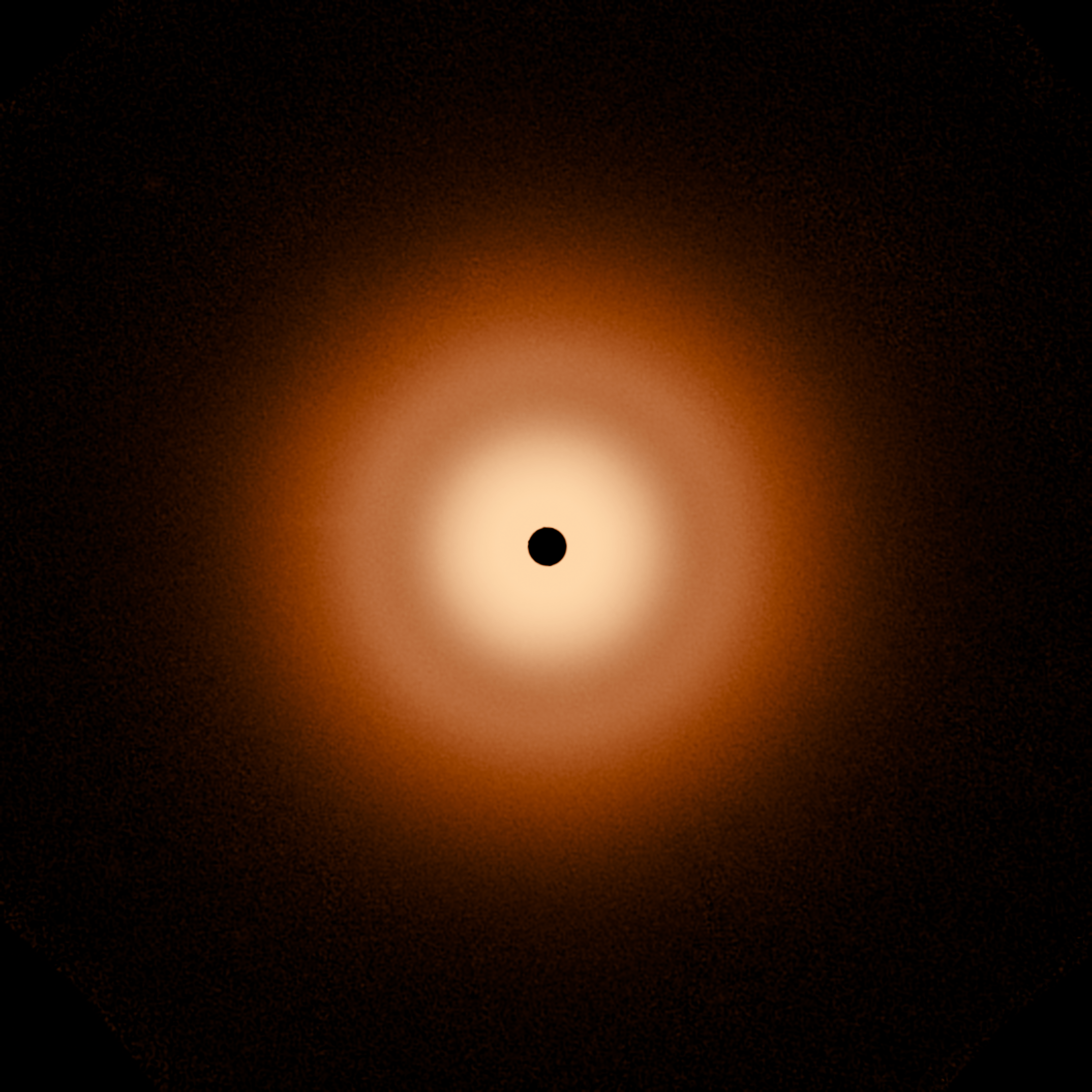 This Webb image of the disk around the star Vega is an orange colored, smooth, fuzzy halo. The inner disk is whiter toward the center, and there is darker lane between the inner disk and the more orange outer disk. The disk is also perfectly circular, with a black circle in the center blocking light from the star.