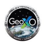 The GeoXO Mission Emblem is shown with the earth in center and the stylized logo type for GEOXO across the center surrounded by a chrome border with the full spellout of the mission acronym being Geostationary Extended Observations.