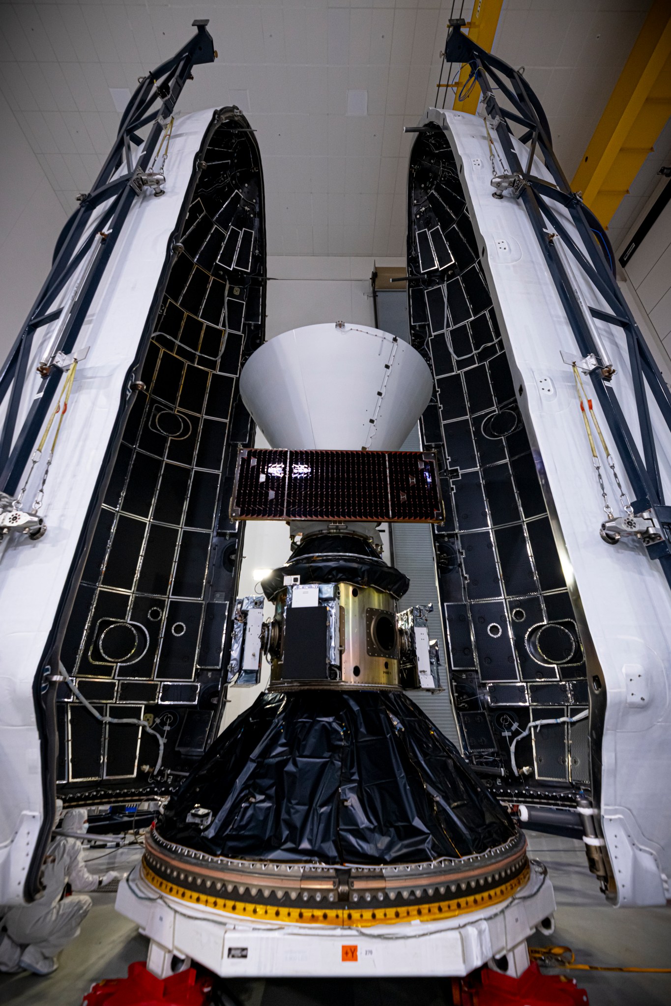 Technicians and engineers encapsulate NASAâs SPHEREx (Spectro-Photometer for the History of the Universe, Epoch of Reionization and Ices Explorer) observatory and PUNCH (Polarimeter to Unify the Corona and Heliosphere) satellites within a protective payload fairing inside the Astrotech Space Operations facility at Vandenberg Space Force Base in California, on Thursday, Feb. 27, 2025. SPHEREx will use its telescope to provide an all-sky spectral survey, creating a 3D map of the entire sky to help scientists investigate the origins of our universe. PUNCH will study origins of the Sunâs outflow of material, or the solar wind, capturing continuous 3D images of the Sunâs corona and the solar windâs journey into the solar system. Liftoff aboard a SpaceX Falcon 9 rocket is targeted for NET 10:09 EST (7:09 p.m. PST), Tuesday, March 4, 2025, at Space Launch Complex 4 East from Vandenberg Space Force Base in California.