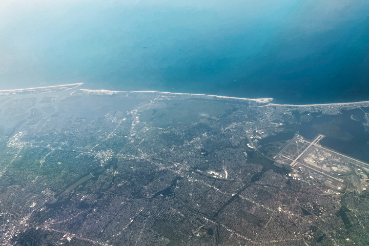 A photo taken from the window of a NASA research aircraft shows part of Queens and Nassau County on Long Island. The photo is looking southward toward the Atlantic Ocean.