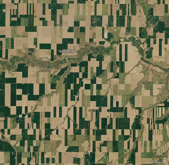 A detailed view of the first image highlights the brown and green agricultural fields around the Teton River. Most of these fields are squares or tall rectangles.