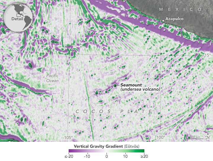 A detailed view of the Pacific Ocean region off the coast of Mexico is overlaid with gravity information that indicates the location of depressions (purple) and elevated features (green) across the seafloor. Numerous seamounts appear as elevated, green dots across the image.