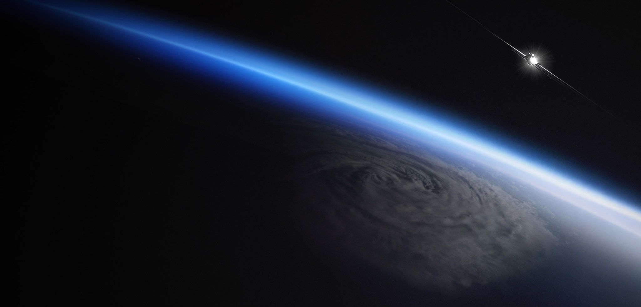 A view from low Earth orbit looking across Earth's curved limb, with a vivid blue atmospheric glow along the horizon against the black of space. Below, a large cloud-covered storm system with a clearly defined cyclonic rotation dominates the surface. In the upper right, a small satellite with extended solar arrays catches direct sunlight, appearing as a bright star-like flare against space.