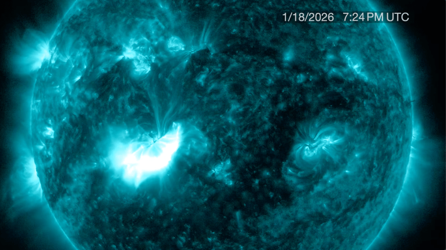 Image of the Sun in blue light with bright solar flares and active regions visible on the surface. The timestamp shows January 18, 2026, at 7:24 PM UTC in the upper right corner.