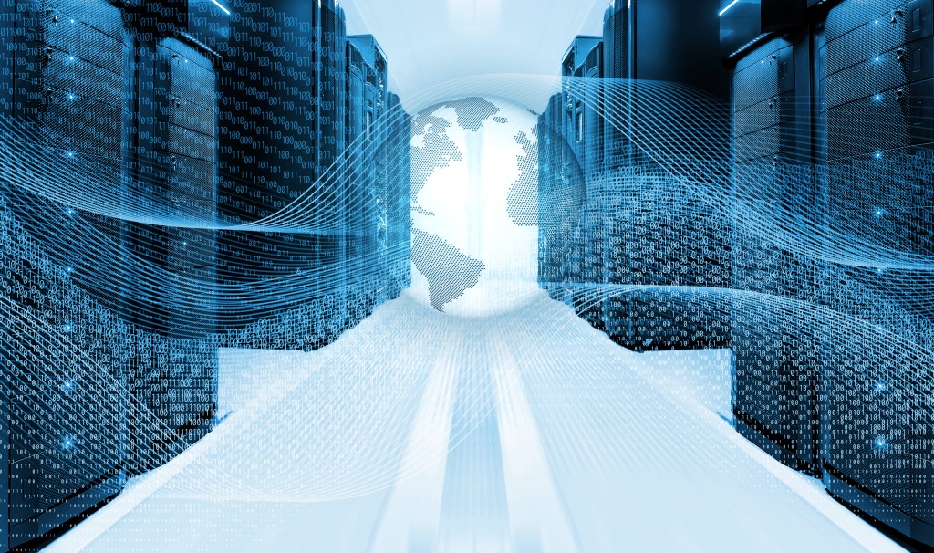 A stock of a globe surrounded by waves of binary code in a data server center.
