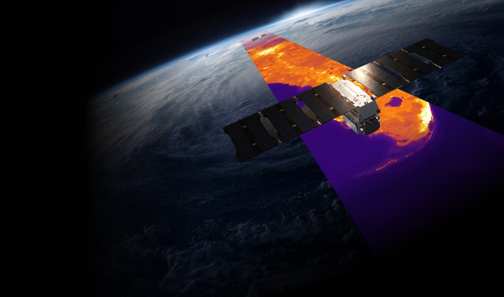 A satellite orbiting Earth, projecting a vibrant thermal imaging swath in shades of orange, yellow, and purple across the planet's surface